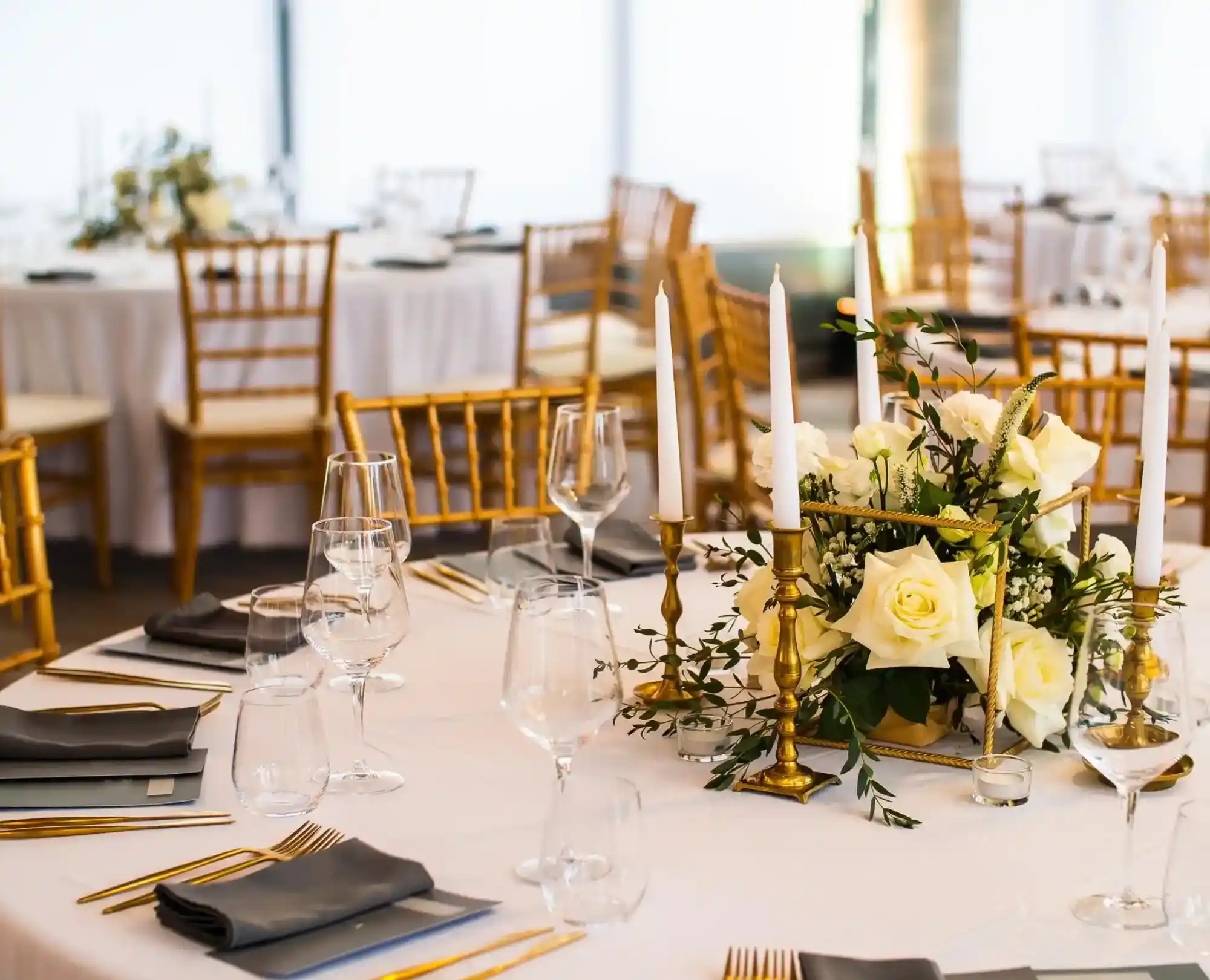 party area with white covered table surrounded by wooden chairs