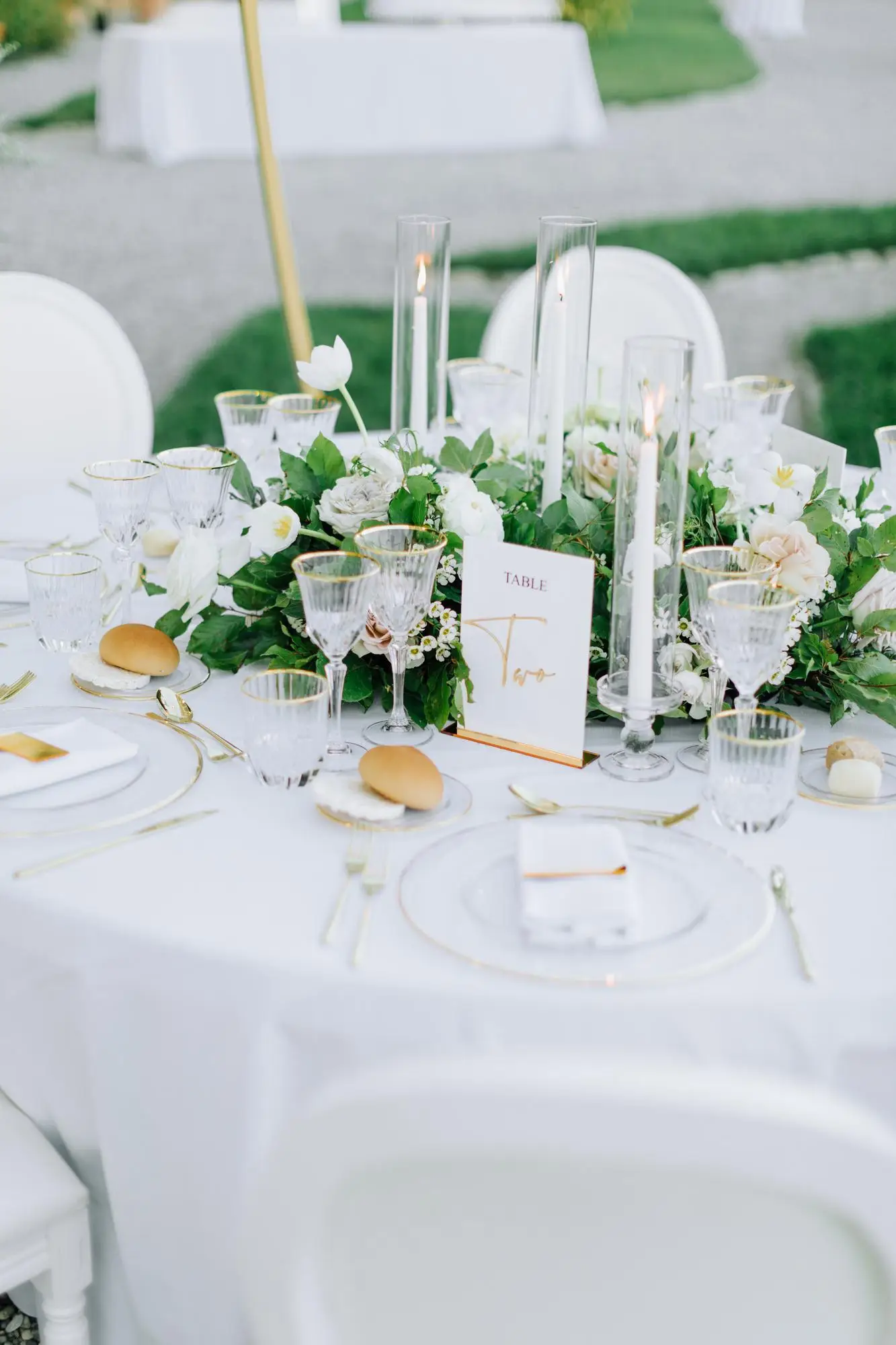 white tabletop with white plate and floral arrangements
